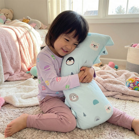 child hugging bamboo pillow with light blue colour and artic animal prints in bedroom