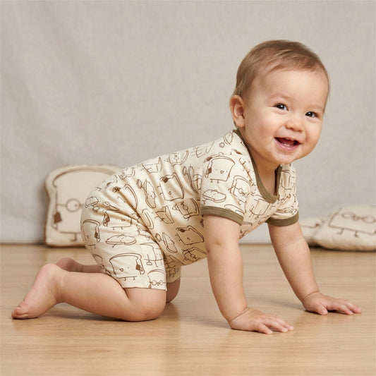 1 years old baby crawling on floor, wearing cuteboid bamboo short rompers which have toast prints