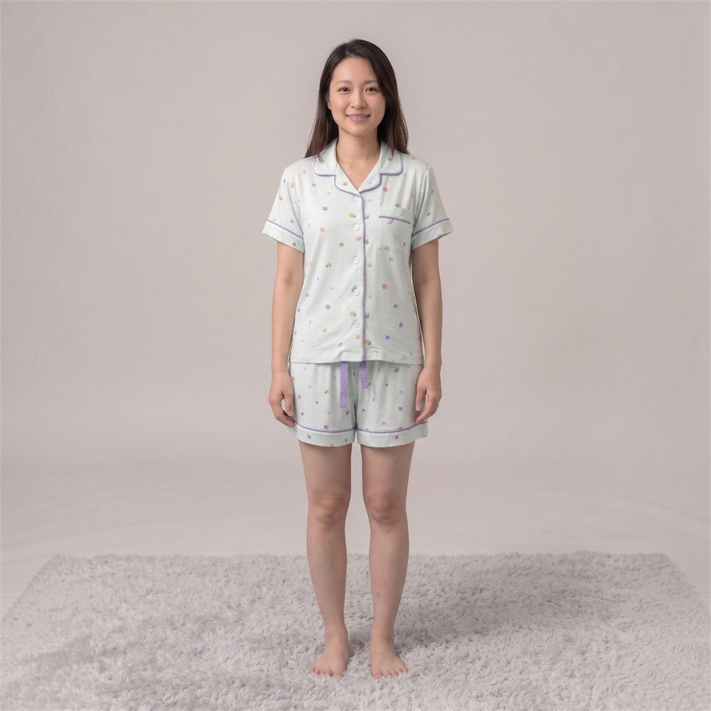 women wearing Cuteboid short sleeve bamboo cooling pyjamas with Little Lagoon design featuring seashell, coral and starfish.