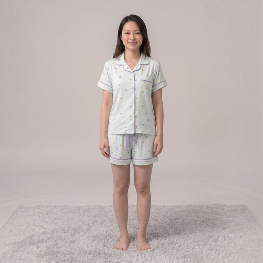 women wearing Cuteboid short sleeve bamboo cooling pyjamas with Little Lagoon design featuring seashell, coral and starfish.